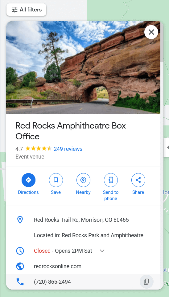 The Google Business Profile listing for the Red Rocks Amphitheatre Box Office, topped by a photo of a red rock formation creating an arch over a road.